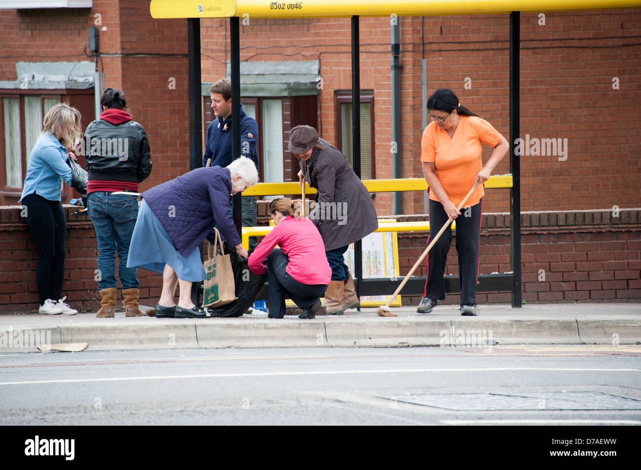 Residents cleaning streets after riot Liverpool Stock Photo