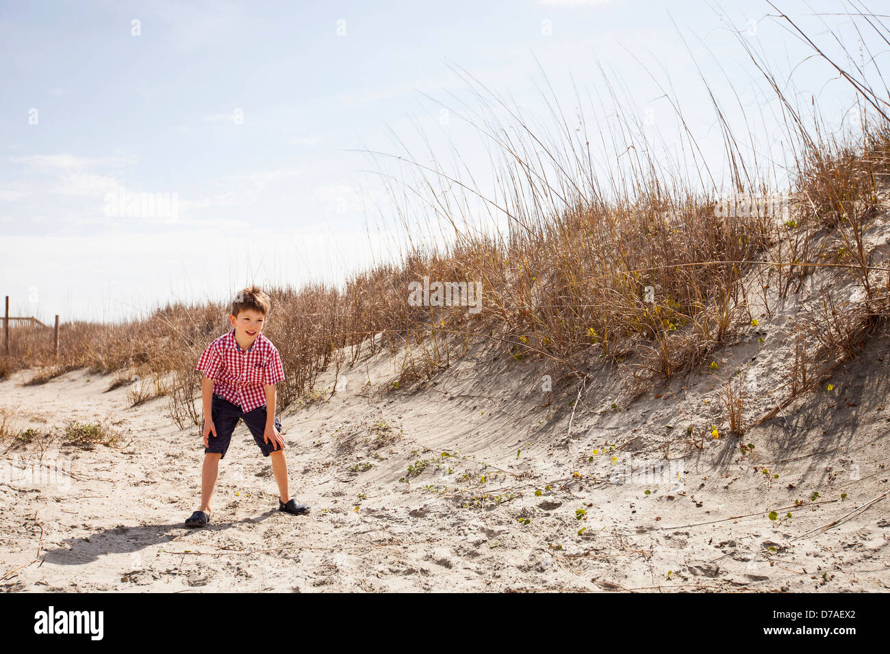 child playing soccer at beach Stock Photo