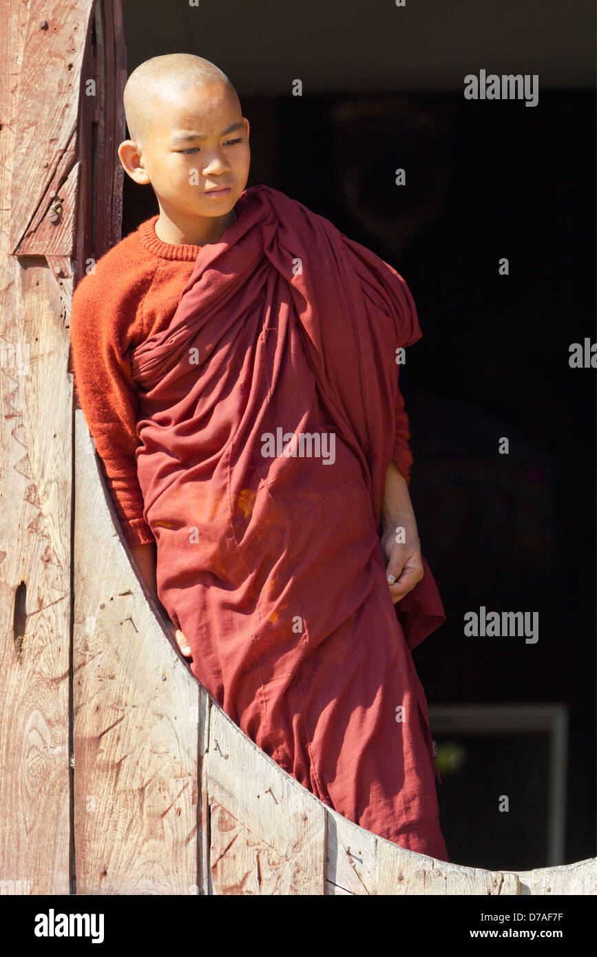A young monk by the window in Shwe Yaunghwe Kyaung Monastery near Lake Inle, Myanmar 8 Stock Photo