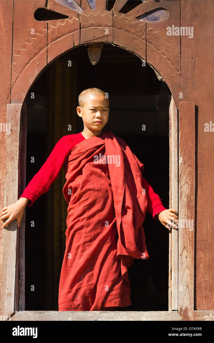 A young monk by the window in Shwe Yaunghwe Kyaung Monastery near Lake Inle, Myanmar 7 Stock Photo