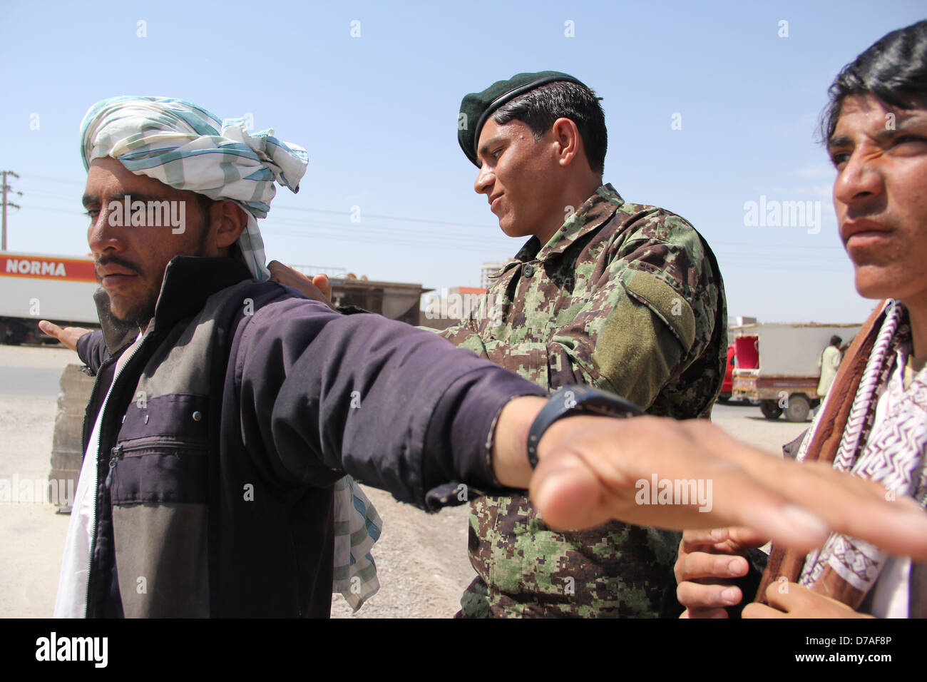 an Afghan national Army checks the people that wants to enter the ANA recruitment center in Herat. Stock Photo
