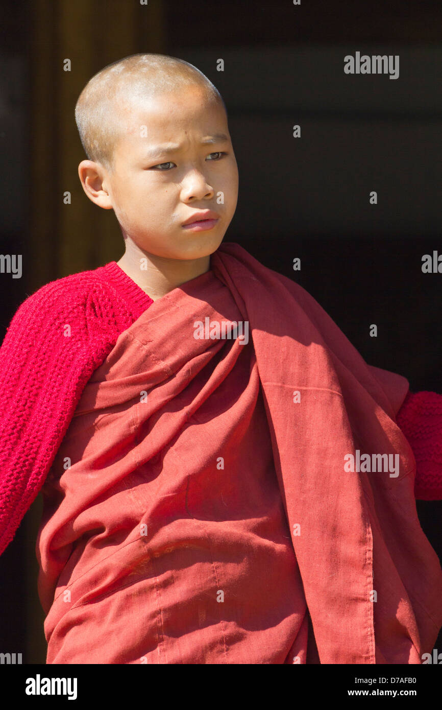 A young monk by the window in Shwe Yaunghwe Kyaung Monastery near Lake Inle, Myanmar 4 Stock Photo