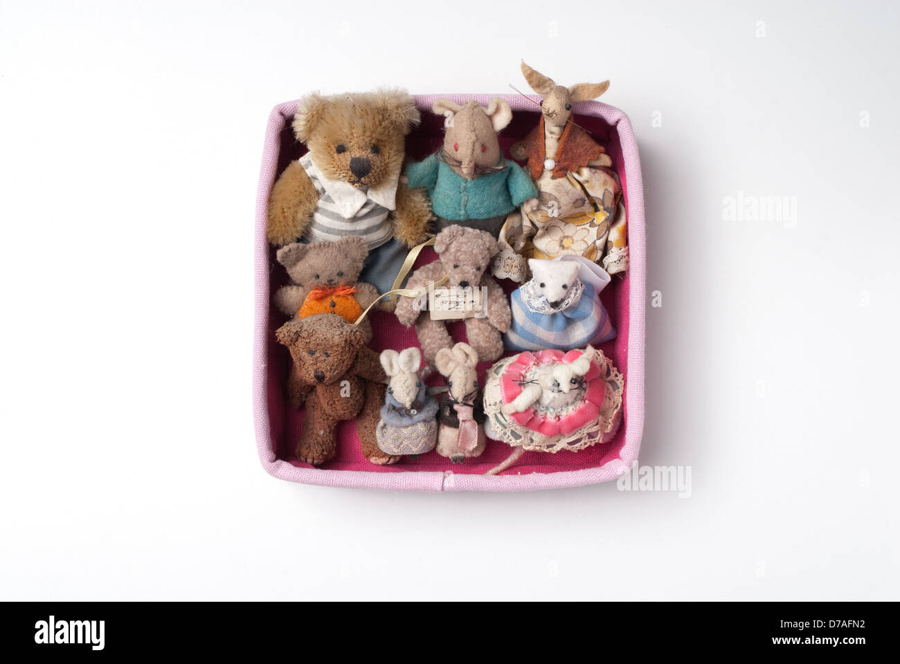 From a series called 'The Pink Box Project'. A collection of miniature teddy bears and mice framed in a pink box. Stock Photo