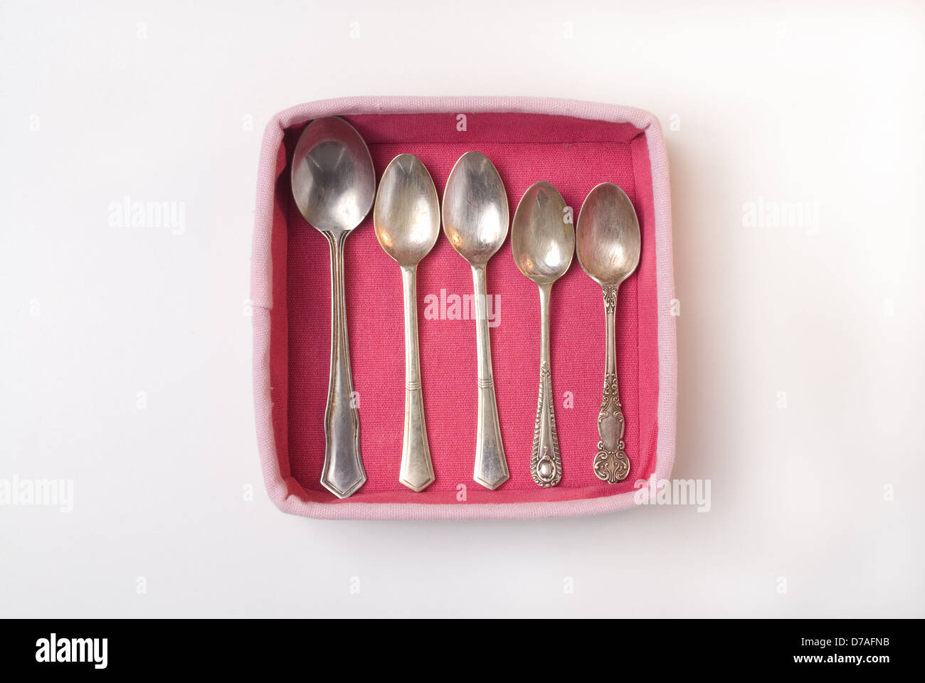 From a series called 'The Pink Box Project' Antique Teaspoons framed in a pink box. Worcestershire, England Stock Photo