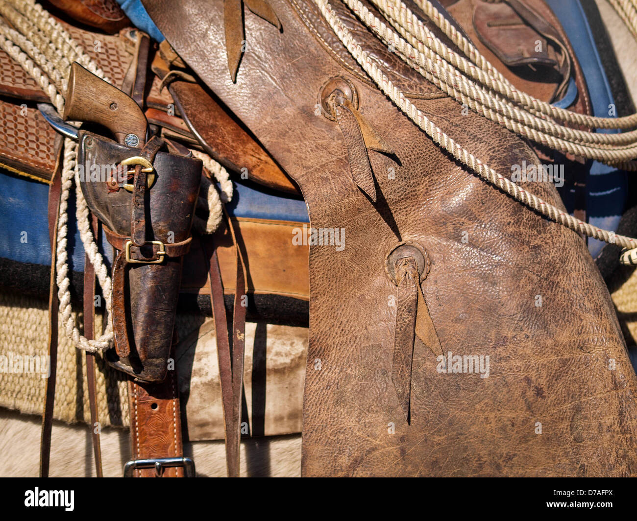 Working  Texas cowboy  saddle with chaps lariat and pistol. Stock Photo