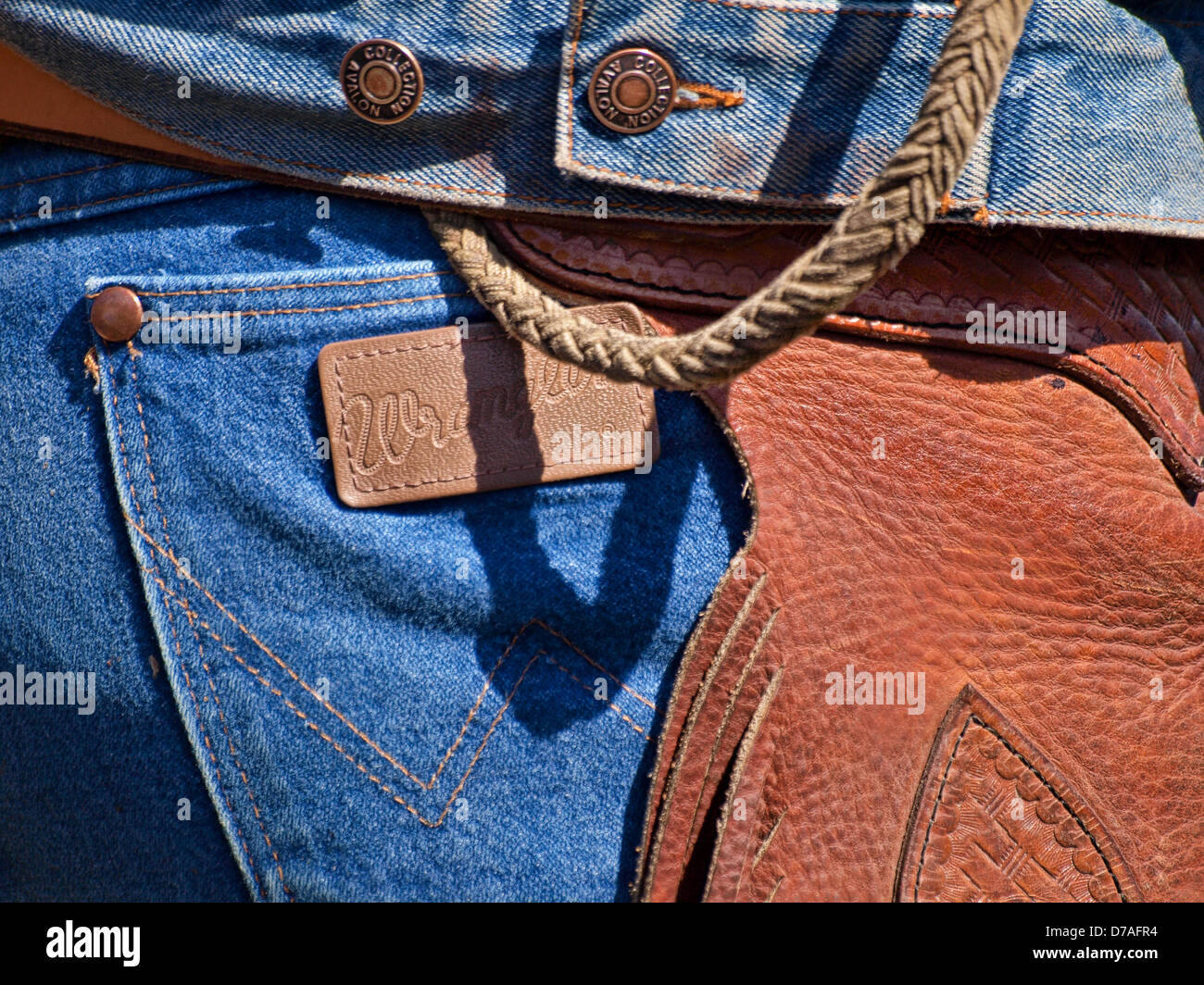 Cowboy in Wranglers and chaps with piggin' string Stock Photo