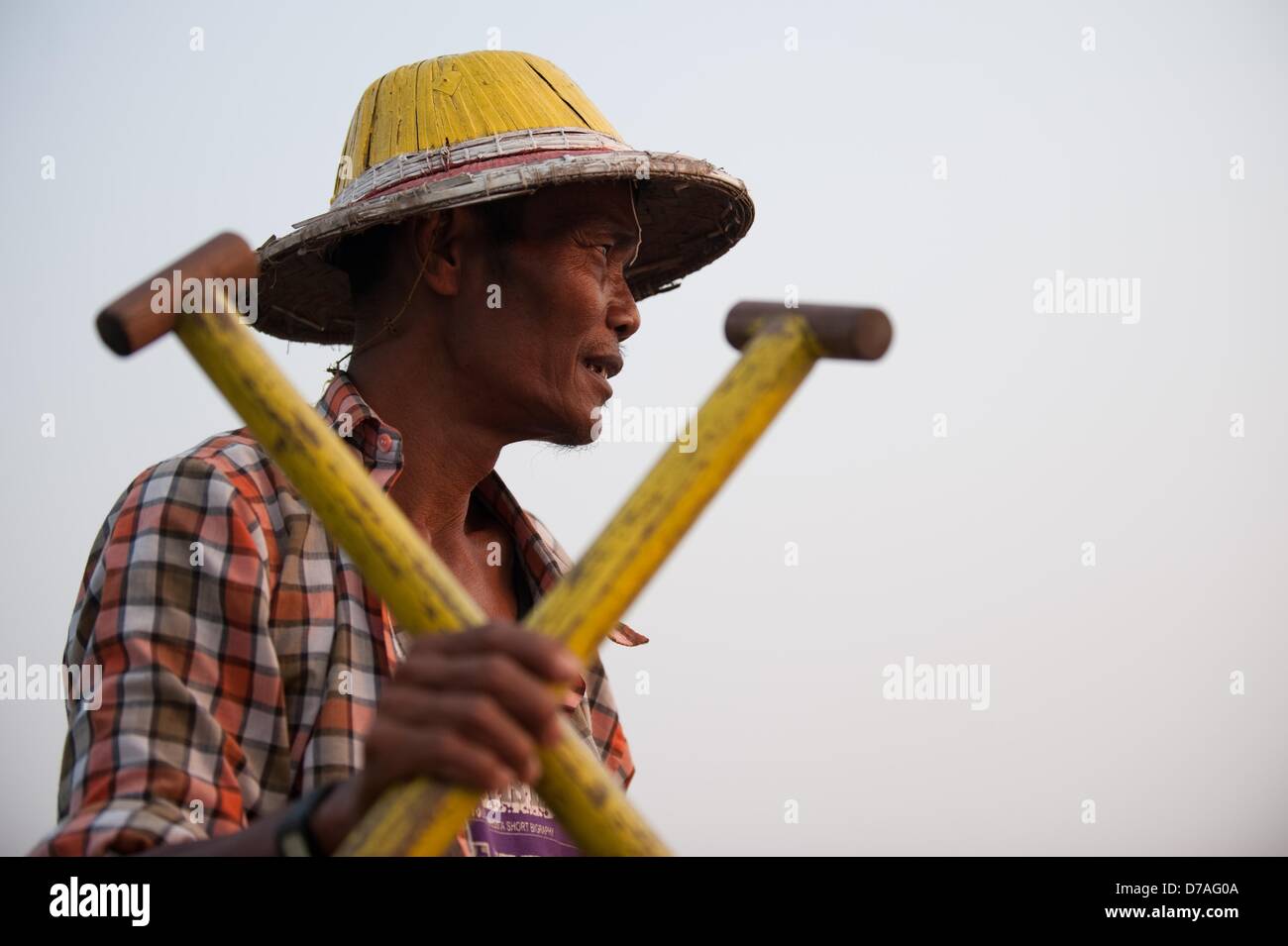 A man rows across the Taungthaman Lake in front of the U Bein Bridge in ...