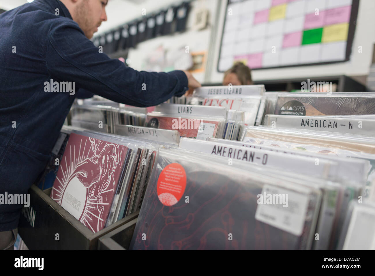 Customer browsing the vinyl LP section in music store Stock Photo