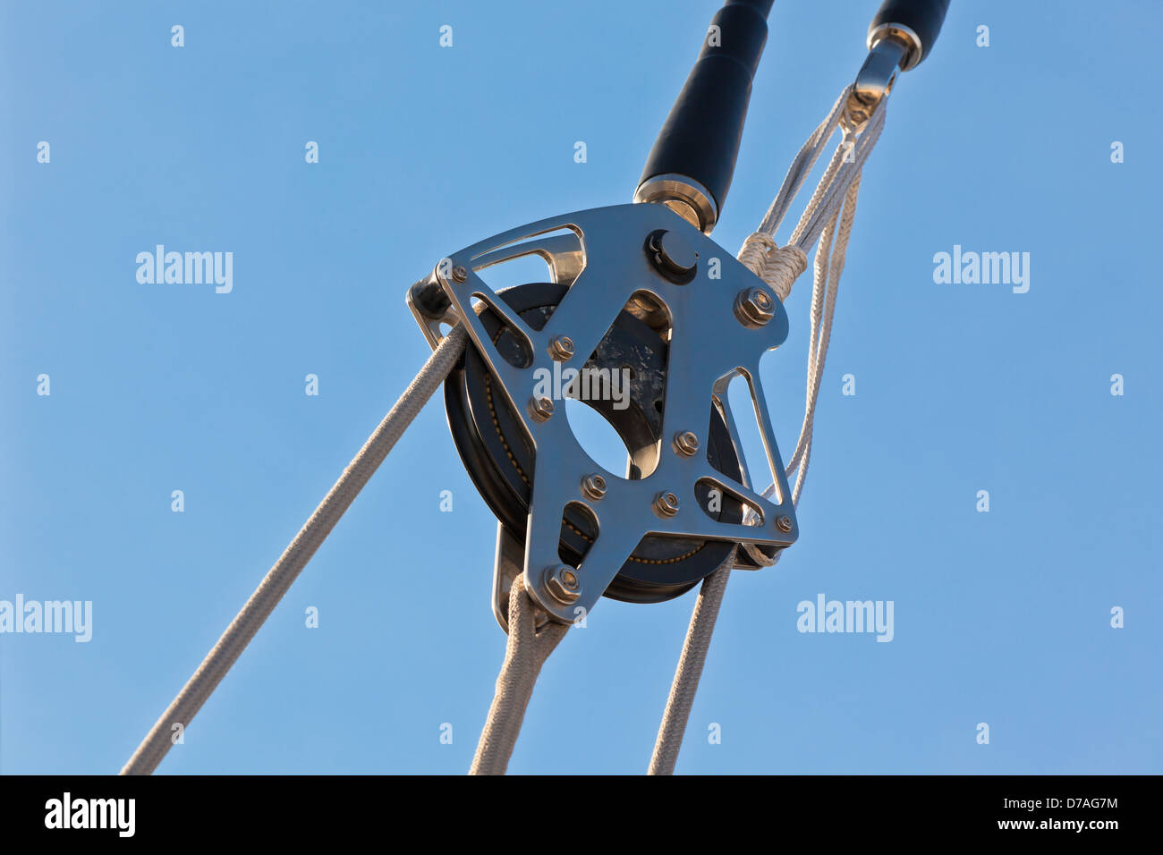 Yacht Pulley Blocks and Ropes against Blue Sky Background Stock Photo