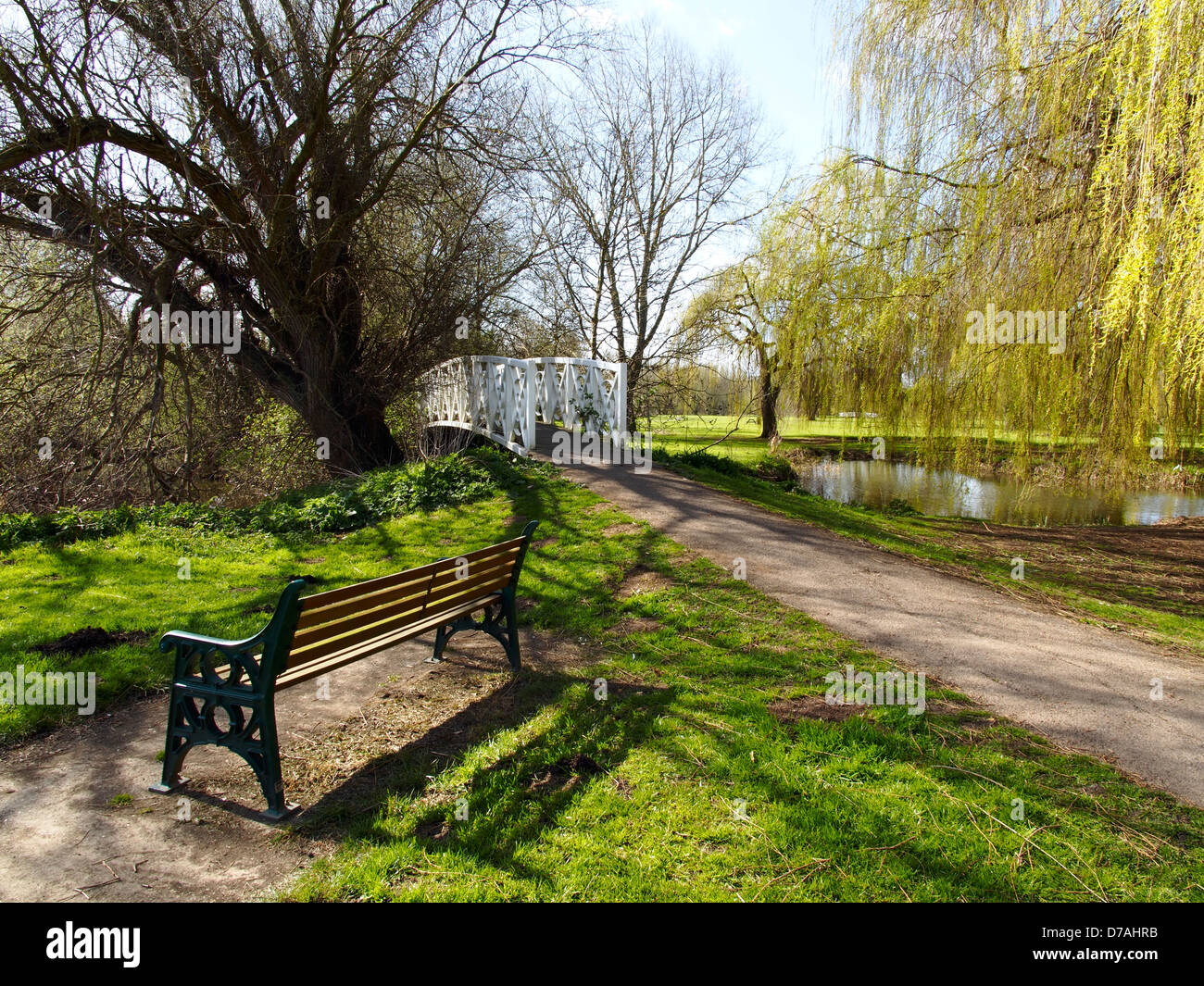 Wooden seat and footbridge Riverside Park St Neots Cambridgeshire Stock Photo