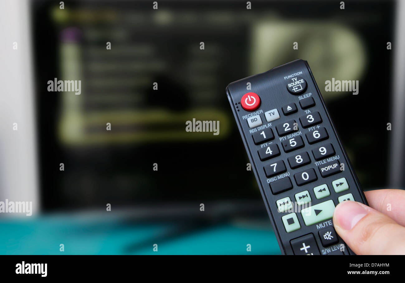 Remote control, TV in background Stock Photo