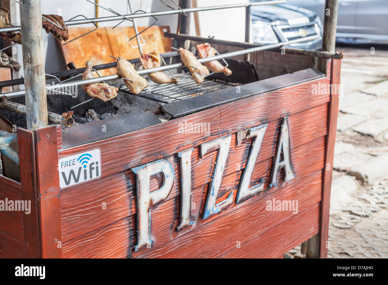 Stall selling pizzas and spit roast chicken joints at Surin Beach