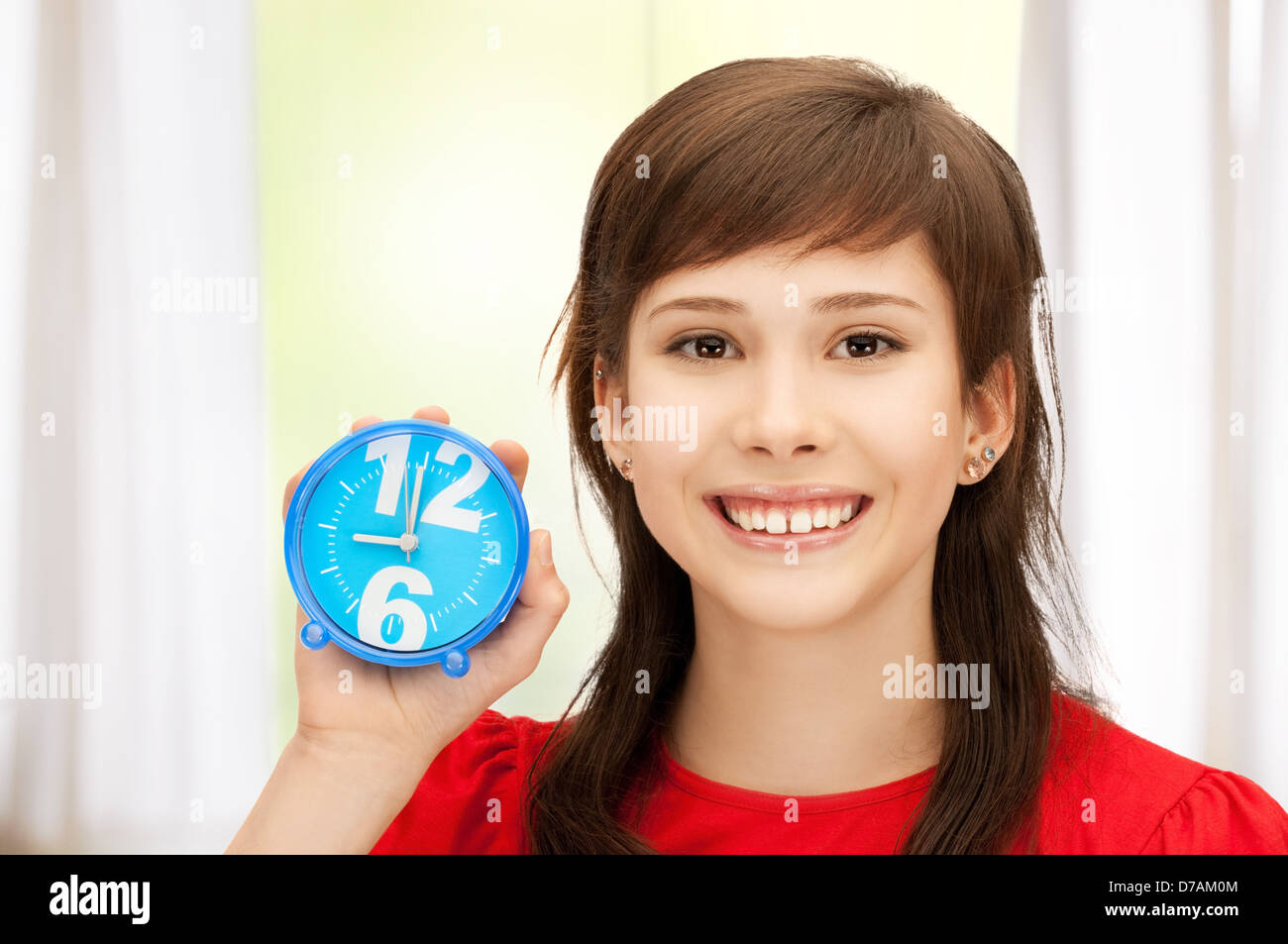 teenage girl holding alarm clock Stock Photo Alamy