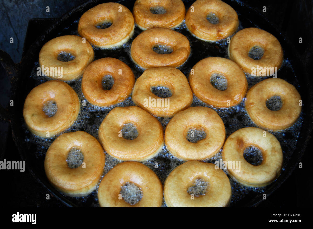 donuts cooking in deep oil in a wok in Kathmandu Nepal Stock Photo