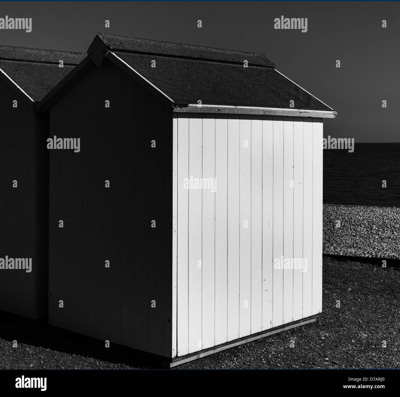 Beach huts on Budleigh Salterton beach in monochrome, Devon, England Stock Photo