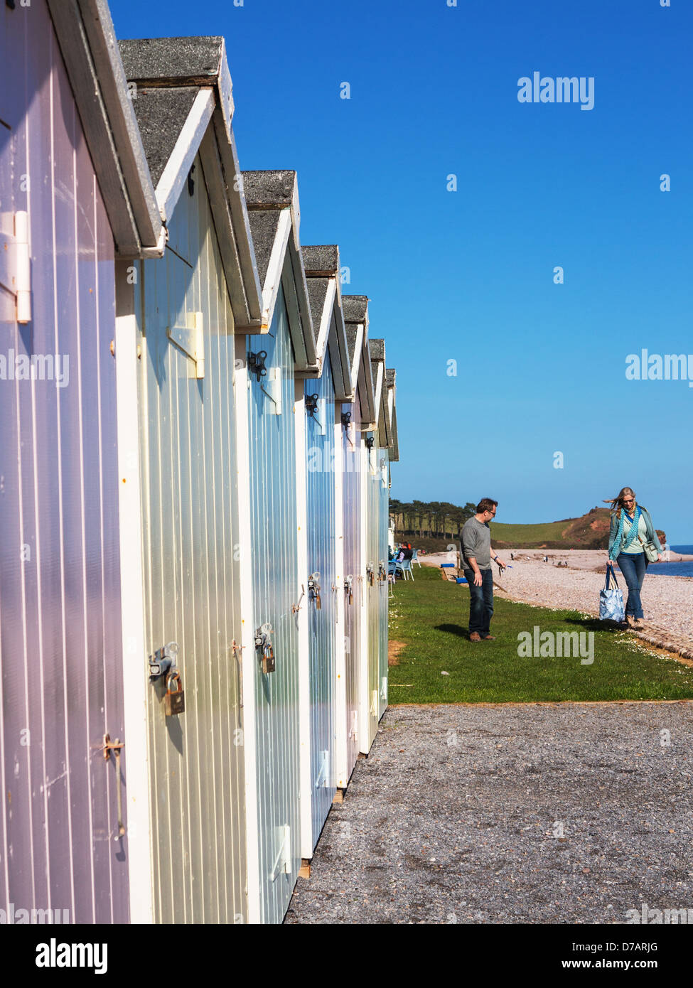 Pastel Coloured Beach Huts And People At Budleigh Salterton Beach Devon England Stock Photo