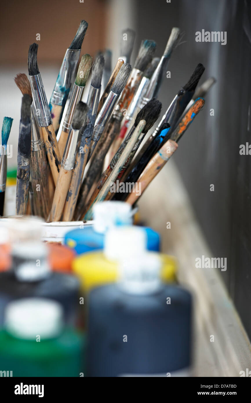 Paint Brushes And Paint Containers In A Classroom Stock Photo