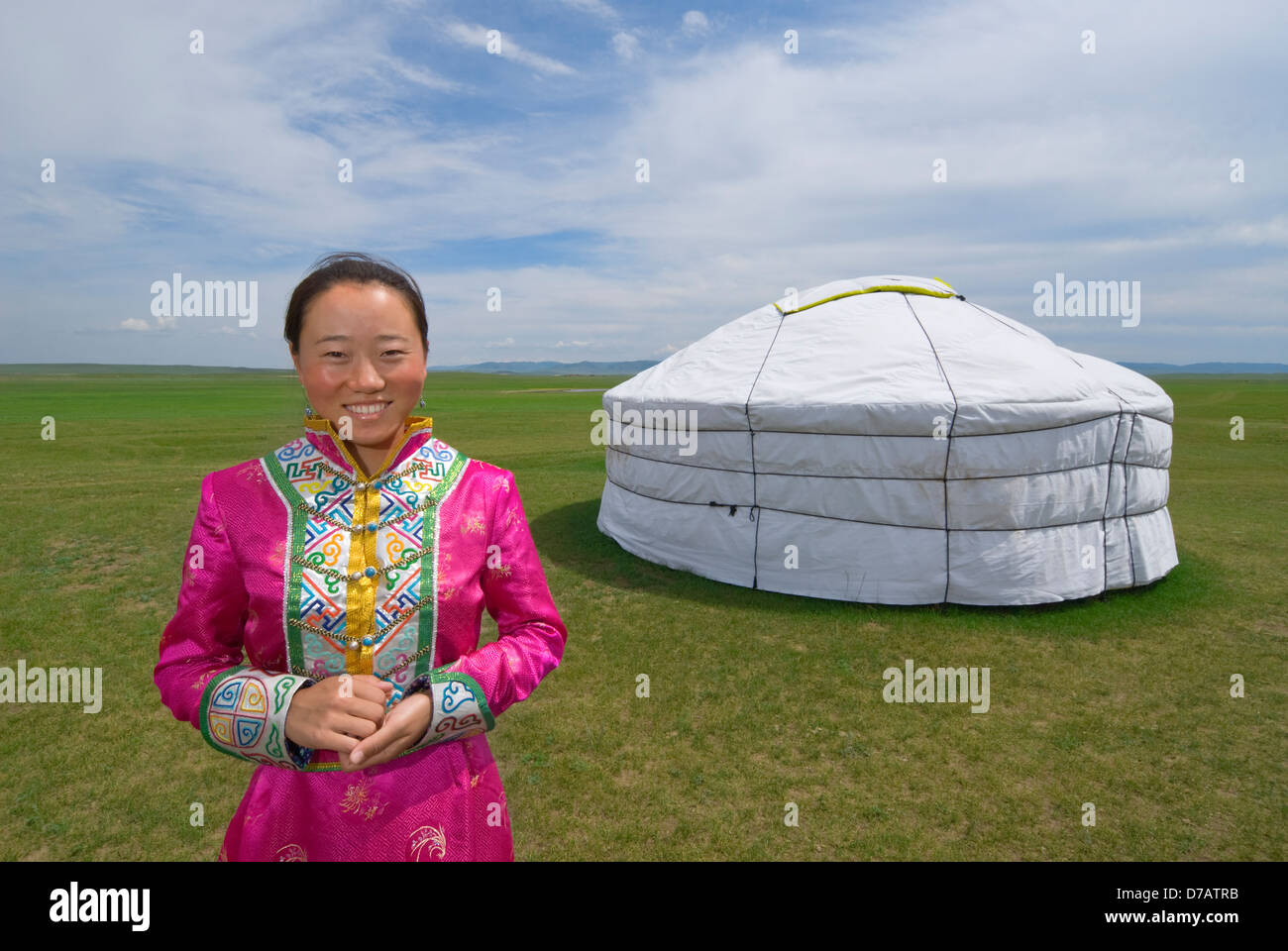 Young woman in front of ger (yurt), Inner Mongolian grasslands, China. Stock Photo