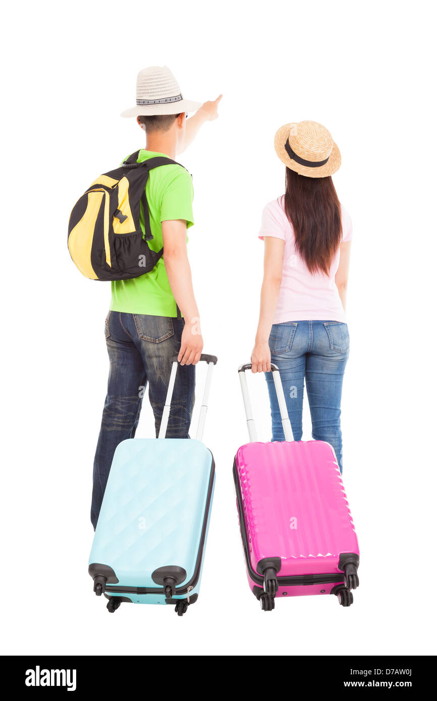 young couple tourist with travel suitcase and pointing something Stock Photo
