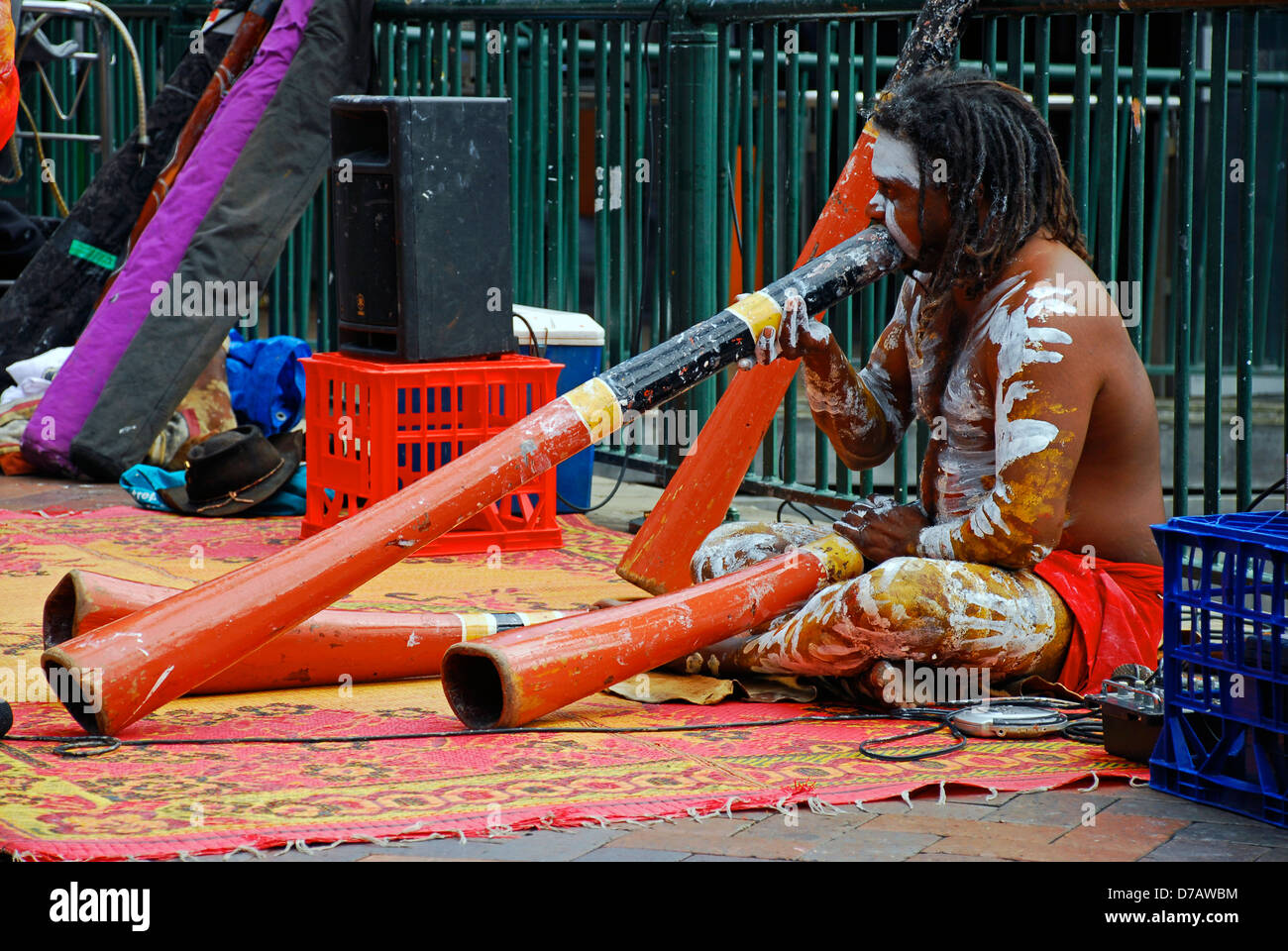 An Australian aboriginal man plays a didgeridoo musical instrument for  tourists out front of Sydney, Australia's, Circular Quay Stock Photo - Alamy