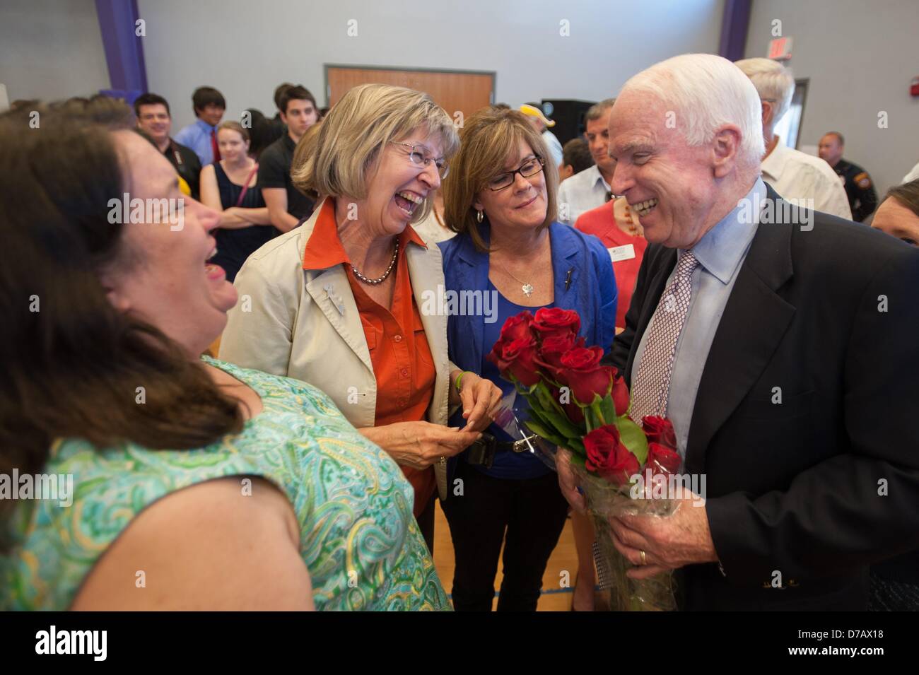 Oro Valley, Arizona, U.S. May 2, 2013. January 8 shooting victims MARY REED, left, and PAM SIMON, center, present Sen. JOHN McCAIN with 19 roses symbolic of the Tucson, Ariz. shooting victims.  McCain held a town hall constituency event at a high school in the Tucson, Ariz. suburb of Oro Valley.  McCain spoke about gun control and immigration, as well as a need to balance the budget to approximately 200 people.  McCain derided the administration for sequestration, and called for a need to de-glamorize drug use as a means of reducing border-related crime. (Credit Image: © Will Seberger/ZUMAPR Stock Photo