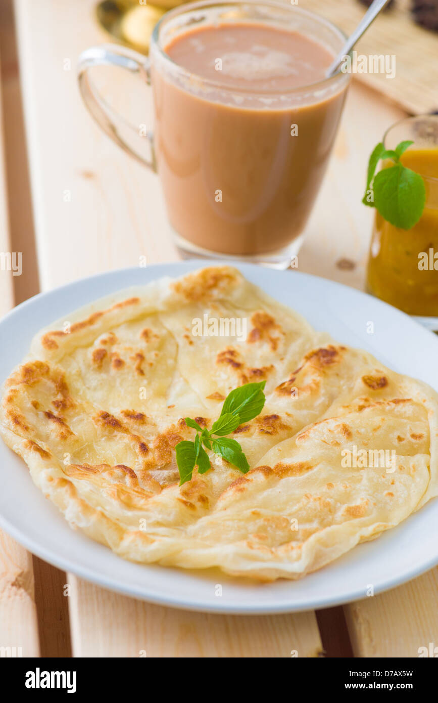 roti canai and teh tarik, very famous drink and food in malaysia Stock Photo