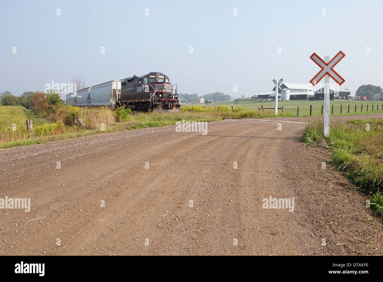 Shortline freight train at crossing; cheltenham ontario canada Stock Photo