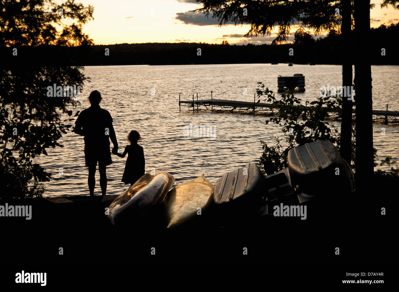 Father And Daughter Watch A Sunset On Beech Hill Pond;Otis Maine United States Of America Stock Photo