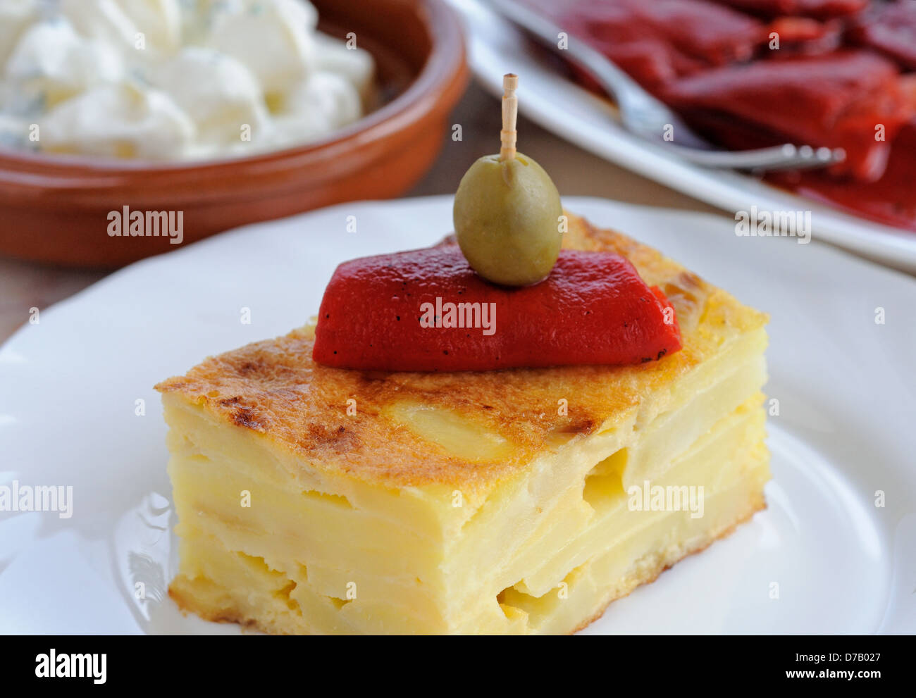 Spanish tortilla topped with red pepper and green olive tapas, Andalusia,  Spain Stock Photo - Alamy