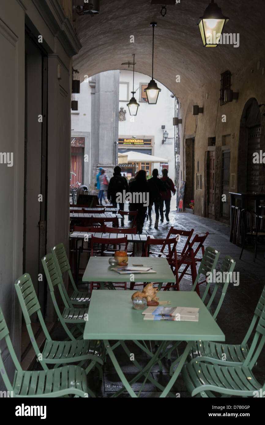 Cafe Table and Chair in Volta di San Pietro Street, Florence, Italy Stock Photo