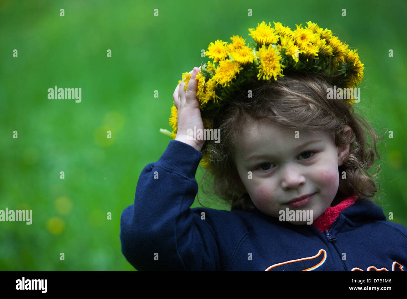 Little girl angel with a flower wreath of dandelions Stock Photo