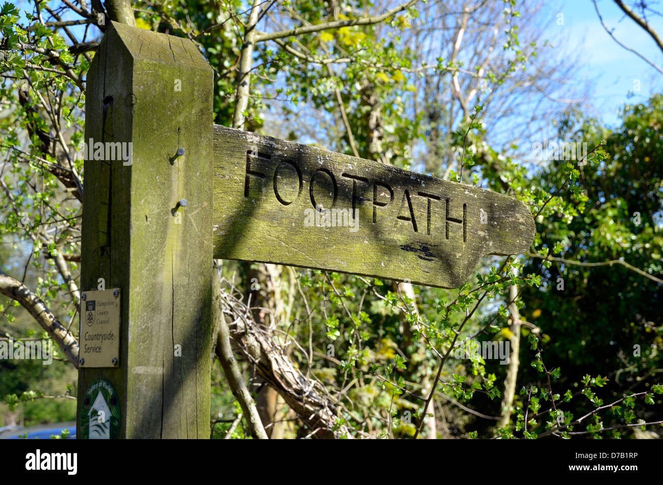 Wooden finger signpost shoing direction of a footpath Stock Photo