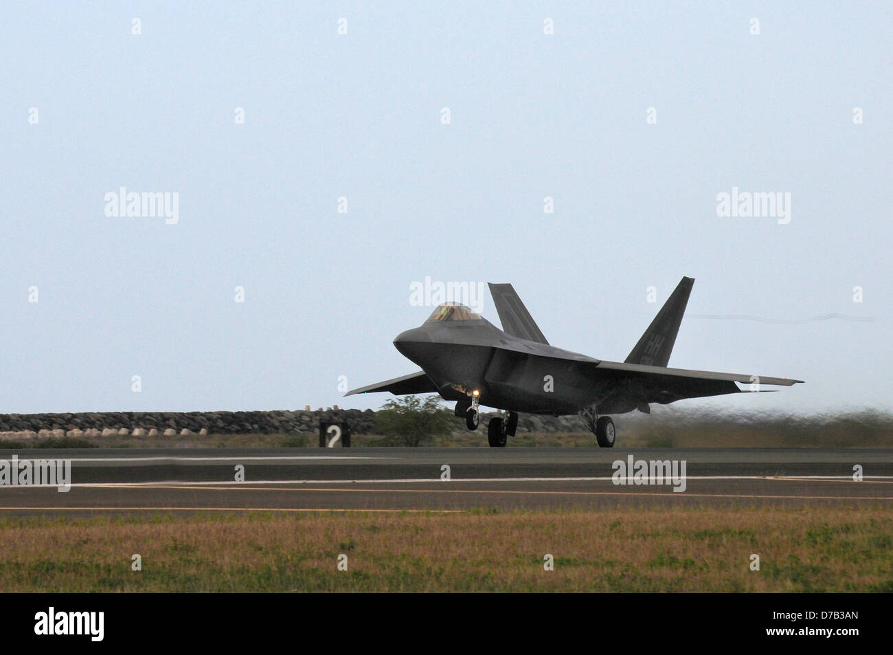 A US Air Force F-22 Raptor stealth fighter aircraft takes off April 6, 2013 at Joint Base Pearl Harbor-Hickam, Hawaii. Stock Photo