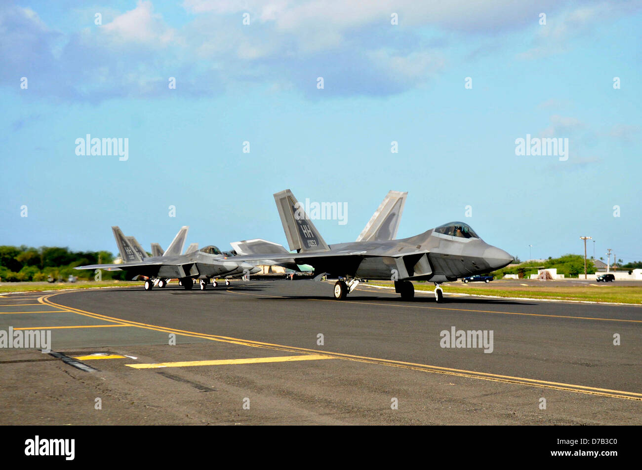 US Air Force F-22 Raptor stealth fighter aircraft taxi to takes off April 6, 2013 at Joint Base Pearl Harbor-Hickam, Hawaii. Stock Photo