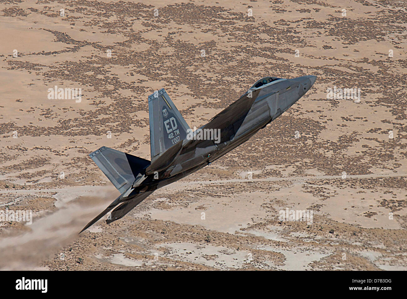 A US Air Force F-22 flies over the desert during a training mission September 27, 2011 at Edwards Air Force Base, CA. Stock Photo