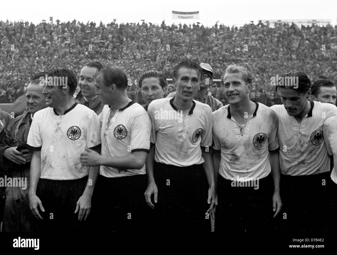 Germany wins the final match of the soccer world championship against Hungary on the 4th of July in 1954 in Bern. The picture shows (l-r) coach Sepp Herberger, captain Fritz Walter, physiotherapist Erich Deuser, Jupp Posipal, team medicine Dr. Franz Loogen, Horst Eckel, Werner Liebrich and Ottmar Walter. Stock Photo