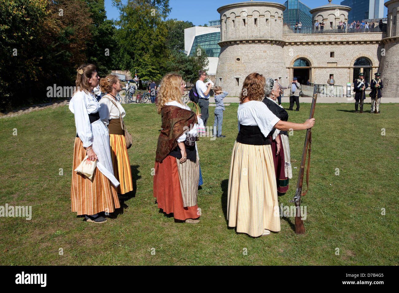 Women with muzzle-loading rifles during a live role-playing in front of the Musée d'Art Moderne Grand-Duc Jean, Luxembourg City, Stock Photo
