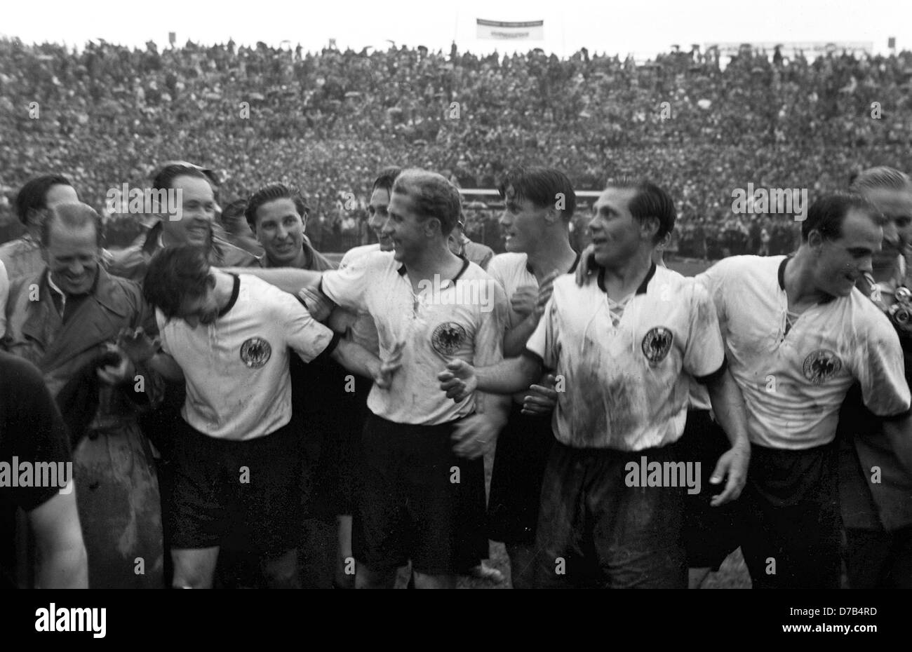 Germany wins the final match of the soccer world championship against Hungary on the 4th of July in 1954 in Bern. The picture shows (l-r) coach Sepp Herberger, captain Fritz Walter, physiotherapist Erich Deuser, team medicine Dr. Franz Loogen, Horst Eckel (half head), Werner Liebrich, Ottmar Walter, Max Morlock and Werner Kohlmeyer. Stock Photo