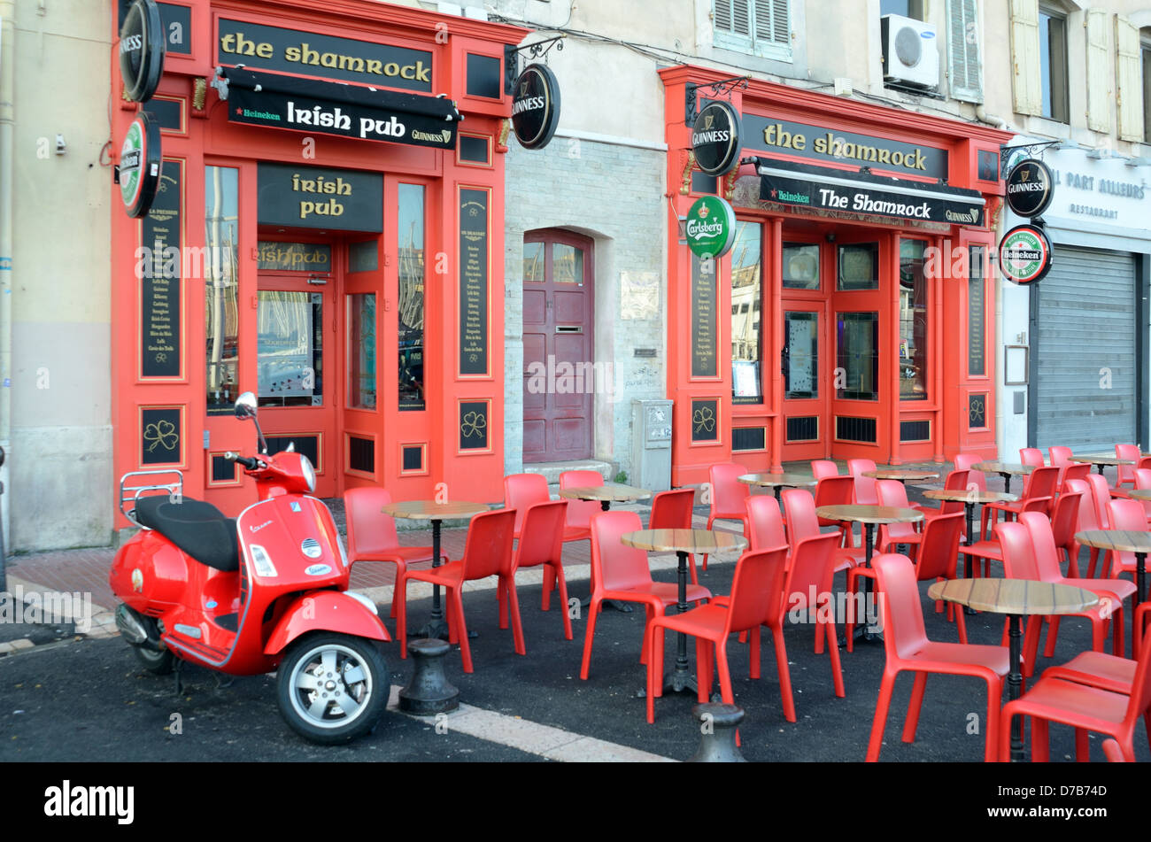 Empty or Desrted Pavement Café at Irish Pub or Bar with Red Tables and Chairs & Red Scooter Marseille Provence France Stock Photo