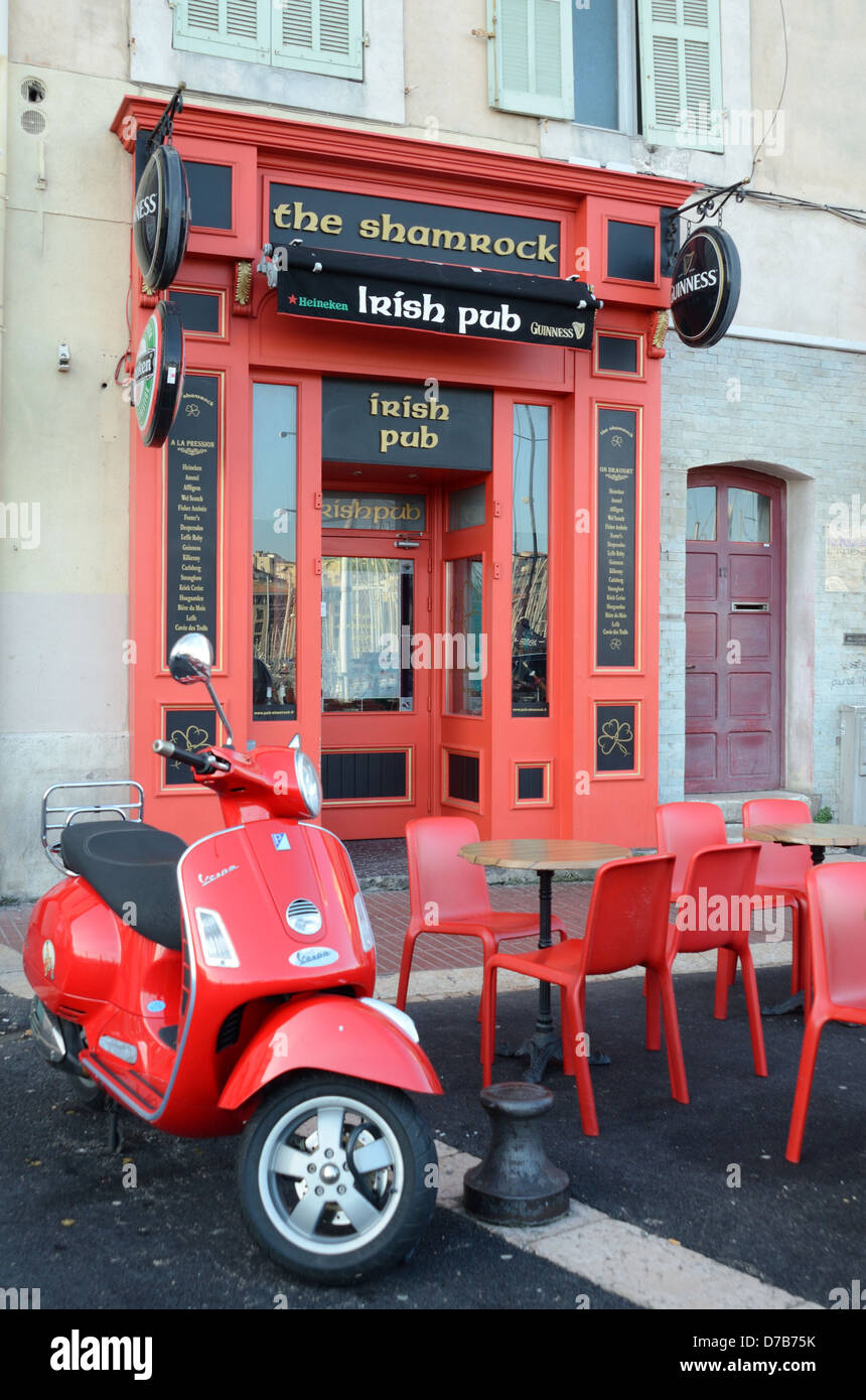 Closed Irish Pub The Samrock & Deserted Pavement Café or Bar with Red Scooter Plastic Tables and Chairs Old Port Marseille Provence France Stock Photo