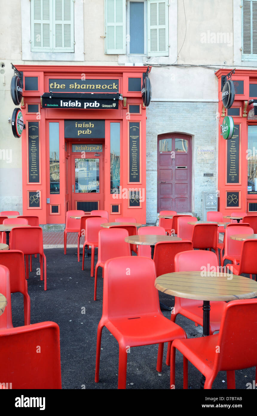 Closed Irish Pub Bar or Pavement Cafe with Empty Tables and Red Chairs Old Port or Vieux Port Marseille Provence France Stock Photo