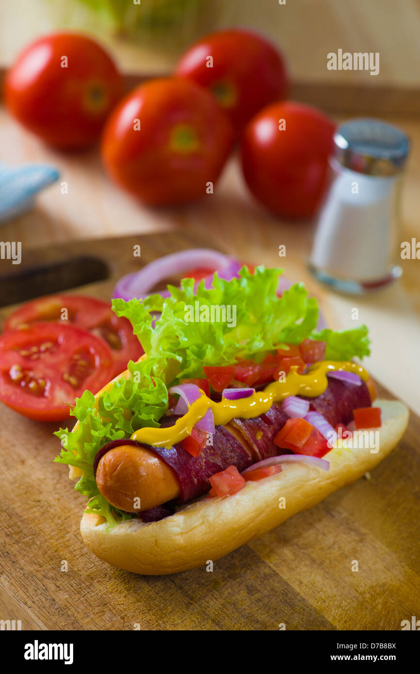 hot dog fast food with plenty of raw ingredients on the background Stock Photo Alamy