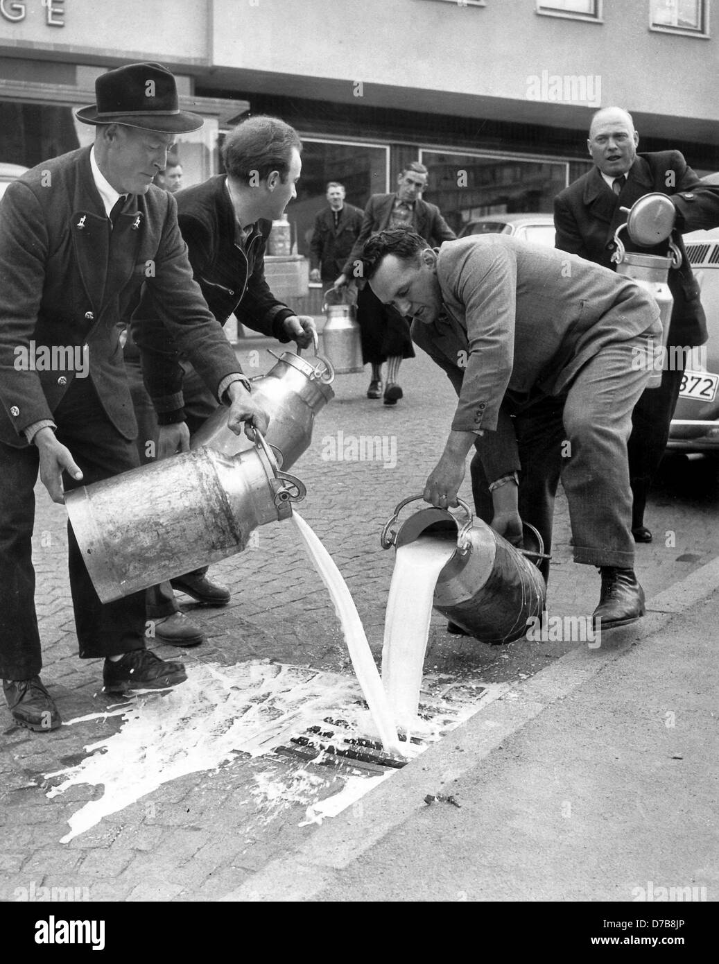Farmers from Zösching pour away their milk into the kerbstone on the 16th of March in 1957 as a