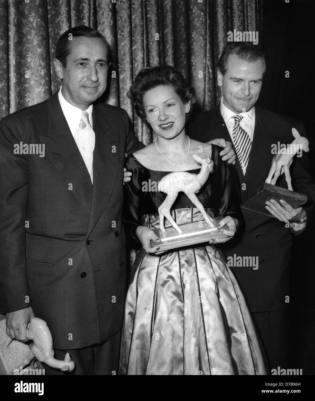 Director Harald Braun (l), actress Ruth Leuwerik (M) and O.W. Fischer (r) after the Bambi Awarding Ceremony on the 27th of December in 1953 with their awards. Stock Photo