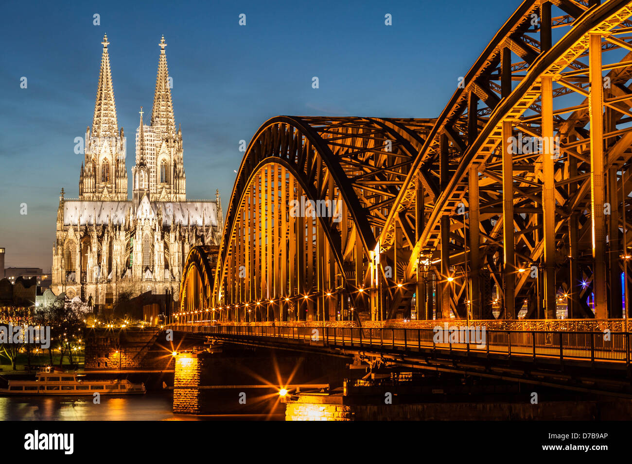 Hohenzollern Bridge and Cologne Cathedral at dusk, Koln, Germany Stock Photo