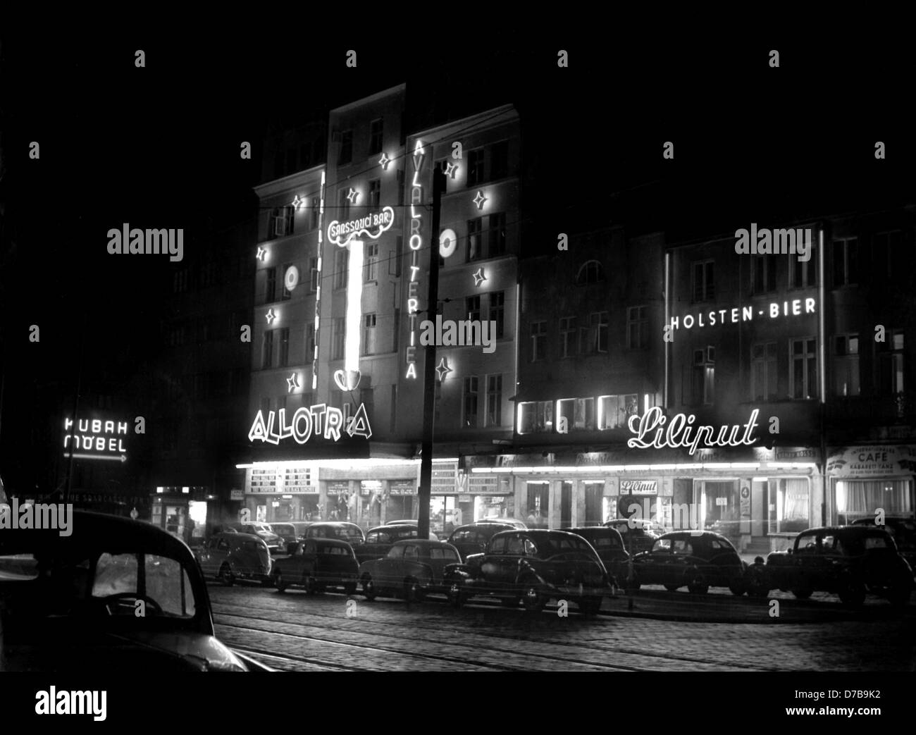 View of the Reeperbahn at night with neon signs in St. Pauli in Hamburg, photographed in 1953. Stock Photo