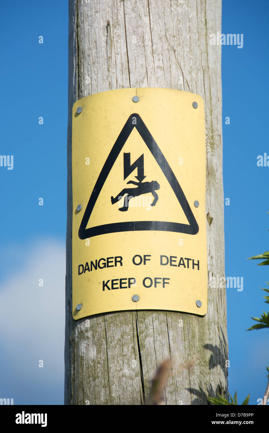 A 'Danger of death' warning on a wooden pole supporting electrical cables. UK, 2013. Stock Photo