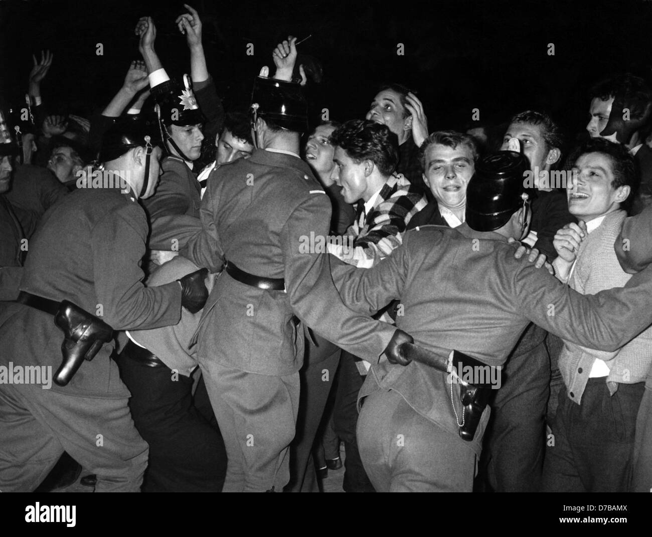 'Rowdies' go wild - police men shove enthusiastic adolescents back during Bill Haley's concert in Frankfurt am Main on the 23rd of October in 1958. Stock Photo