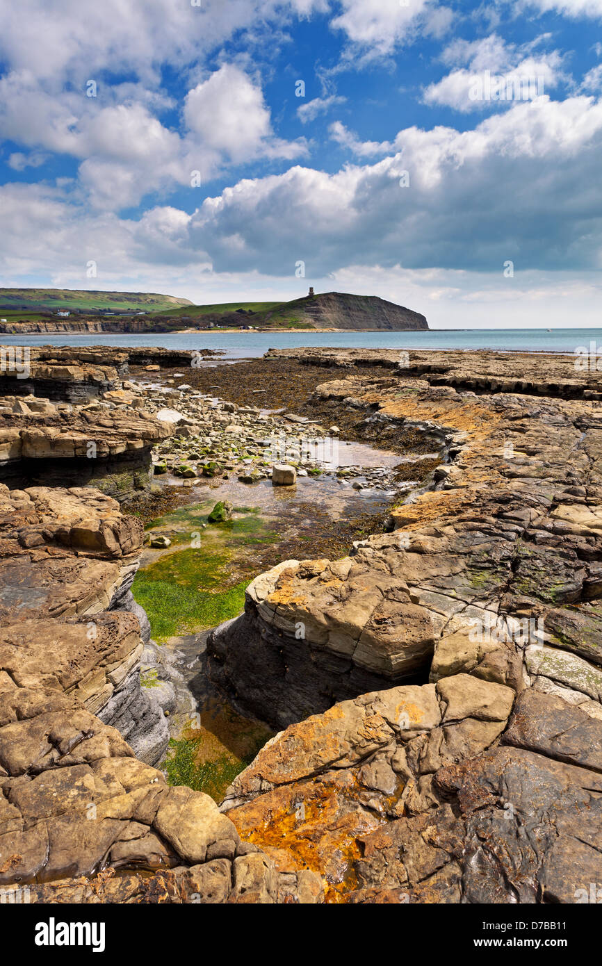 Kimmeridge Bay in the Dorset taken from the west side at low tide looking across the bay towards Clavell Tower Stock Photo