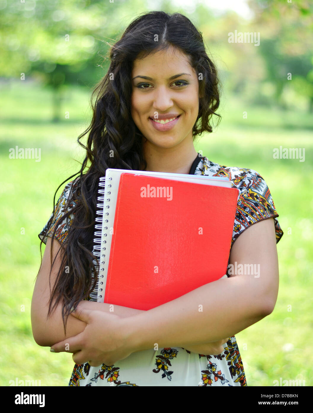 Portrait of happy student girl holding books outdoor Stock Photo - Alamy